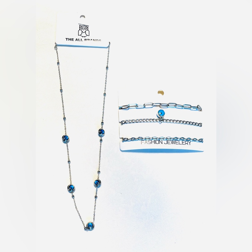 Silver tone chain necklace & three chain bracelets set with blue evil eye balls